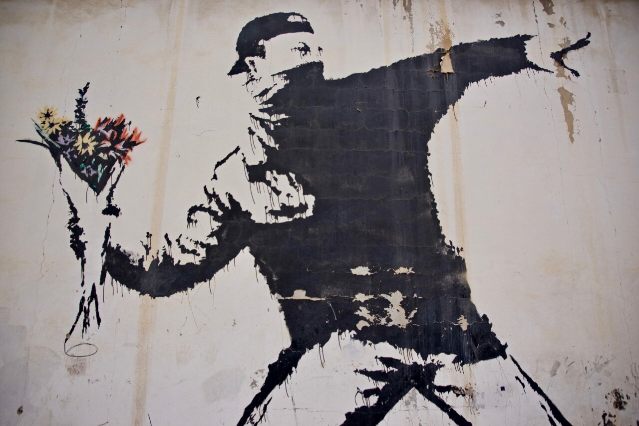 Banksy – Love Is In The Air, Flower Thrower, 2005, Ash Salon Street, Bethlehem, West Bank, CC BY-NC-SA 2.0 by jlevinger.